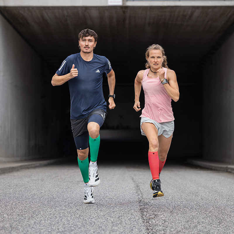 Ab in den Feierabend! Mit der richtigen Lauftechnik geht's noch entspannter Mann mit langen Laufsocken läuft auf einer Promenade in Richtung Sonnenuntergang