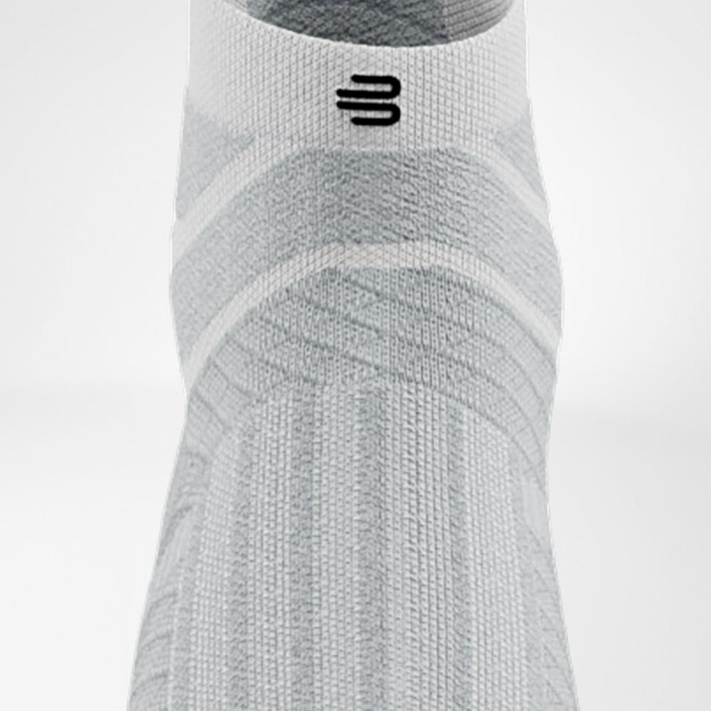 Weiße Run Performance Low Cut Socke von Bauerfeind in Frontalansicht, mit deutlich sichtbarer Struktur auf dem Fußrücken und elastischem Schaft.