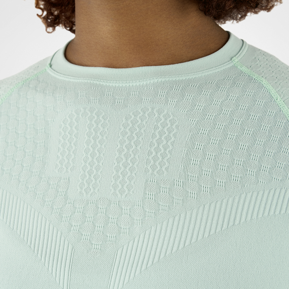 Nahaufnahme eines mintgrünen Kompressionsshirts mit strukturiertem Gewebe, das die Textur und Details des Materials zeigt.