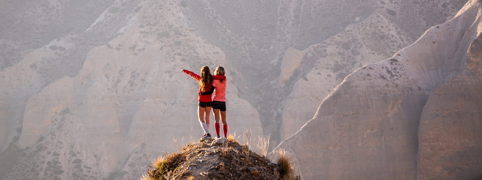 Zwei Frauen jubeln auf einem Berggipfel